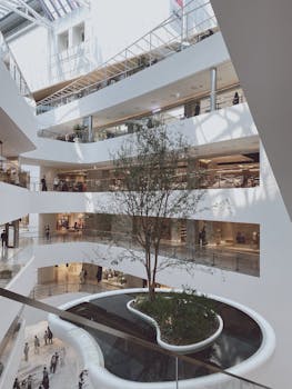 Spacious interior of a shopping mall in Seoul with modern design and natural light.