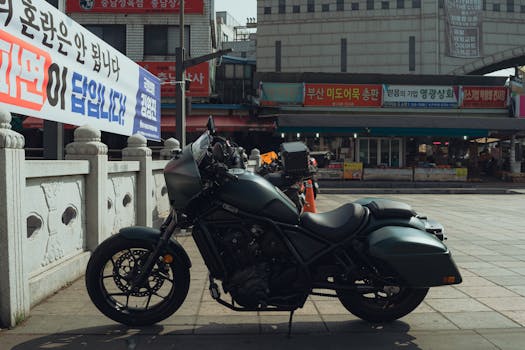 A sleek motorcycle parked in the vibrant streets of Seoul, South Korea, showcasing local architecture.