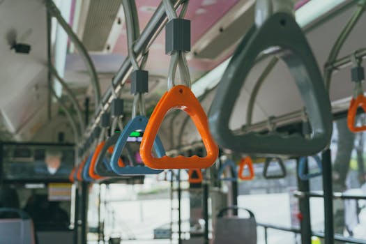 Close-up of passenger handles inside a Seoul city bus, highlighting daily commute in Korea.