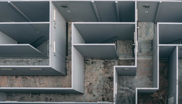 Aerial view of a complex indoor labyrinth made of concrete walls.
